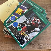 Stack of assorted hockey trading cards with Eric Lindros Philadelphia Flyers card visible on top