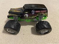 Side view of Hot Wheels Grave Digger monster truck toy
