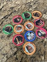 11 Star Wars Episode I pog discs displayed on countertop