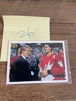 Front of the Gretzky & Coffey Upper Deck card in sleeve beside lot number