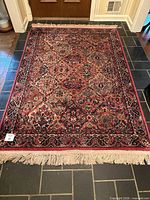 Full view of rectangular rug showing overall pattern and fringe