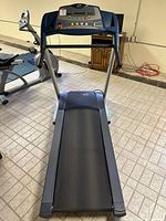 Front perspective of Essential treadmill showing running belt and console