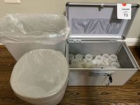 Case open beside two trash bins showing jars inside