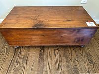 Front view of closed blanket chest on casters