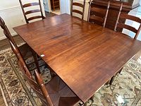 table fully extended with six chairs around