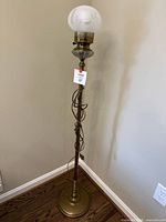 Full view of brass floor lamp with shade and cord