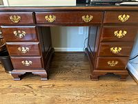 Front view showing full desk, drawer arrangement, glass top