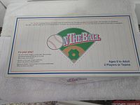 On The Ball game box lid showing title, baseball diamond logo, age range and player count