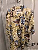 Front view of K.A.D tropical print shirt on hanger