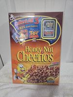 Front of Honey Nut Cheerios box showing Toy Story 2 card game promotion