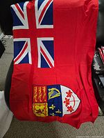 Unfolded Canadian Red Ensign flag showing design and colors