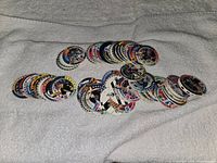 Wide view of entire assortment of pogs spread on towel