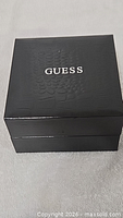 Closed black Guess presentation box