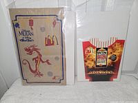 Mulan paper bag and Armageddon fry container fronts