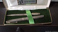 Pen and pencil set displayed in open Sheaffer case