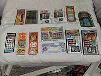 Overview of assorted unscratched lottery tickets laid out in two rows