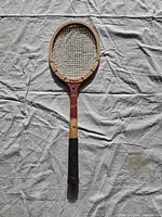 Full view of Wilson Stan Smith Capri wooden tennis racket on cloth background