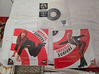 Front view of all three records showing Bowie clear vinyl and two Imperial Surfers picture sleeves