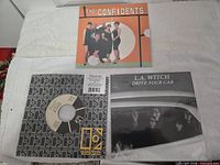 Front covers of all three sealed 7-inch singles