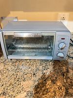 Front view of Black+Decker stainless steel countertop toaster oven on counter