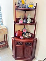 Full view of corner cabinet showing shelves and lower doors