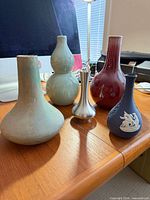 All five vases grouped together on desk