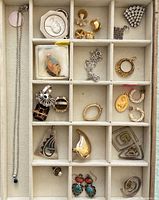 Overall view of tray showing entire mixed jewelry assortment