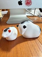 Both ceramic cow figurines side by side