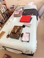 Full view of Tempur Ergo adjustable base under bedding, metal guard rail visible