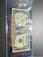 Front of Series 1935 $1 silver certificate in protective sleeve showing serial Z94820644G