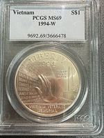 Front of PCGS-slabbed 1994-W Vietnam Veterans Memorial silver dollar showing label and obverse design