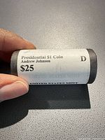 Front view of sealed United States Mint roll showing label: Presidential $1 Coin Andrew Johnson $25 D