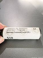 Paper-wrapped roll labelled for 2016 Shawnee National Forest quarters, $10, D mint