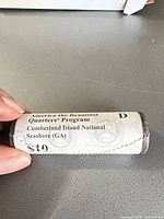Paper-wrapped quarter roll marked America the Beautiful Quarters Program Cumberland Island National Seashore (GA) $10, letter D
