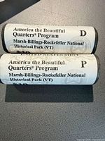 Two Mint-wrapped quarter rolls showing program name and park designation