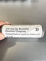 Side view of sealed roll with America the Beautiful Quarters Program text, Denver mint mark and National Park of American Samoa labeling
