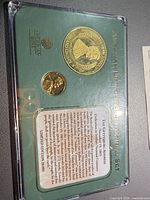 Front view of sealed display showing both coins and Gettysburg Address text