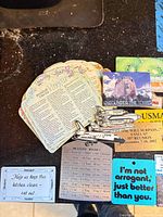 Assorted magnets with recipes, humor, measurement chart, tourist and commemorative designs on countertop