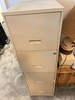 Front view showing four drawers and lock