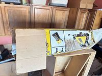 Repurposed DeWalt cardboard box containing rolled blueprint sheets