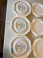 Undersides of three Bradford Exchange Buffalo Caller plates in original foam inserts showing maker’s marks and edition information