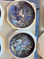 Two plates showing unicorn and fairy scenes