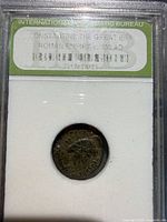 Encapsulated bronze Roman coin of Constantine I in slab with label