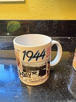 White ceramic mug with 1944 D-Day commemorative graphics