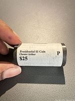 Close-up of sealed Presidential $1 coin roll label showing president name and $25 face value