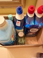 Top view of all five bottles in cardboard box