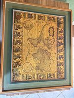 Front view of framed vintage-style world map with matting and wood frame