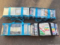 Four zippered clear vinyl totes filled with VHS tapes