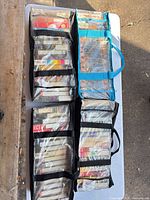 Group of five soft VHS cases filled with tapes on table