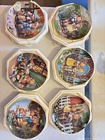 Top-down view of six framed Hummel plates